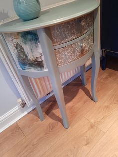 a blue vase sitting on top of a wooden table next to a radiator