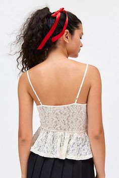 Ultra sweet Ecote tank top in a floral lace jacquard fabric. Designed in a peplum silhouette featuring a plunging v-neckline with triangle cups, a fitted bodice and floaty ruffled hem. Topped with a satin bow & lace trim for a femme finish. Find it only at Urban Outfitters. Features Ecote Elise jacquard lace peplum cami Empire waist tank top Semi-sheer floral lace jacquard fabric Plunging v-neckline with triangle cups, satin bow and spaghetti straps Fitted empire waistline Floaty flared hem Stre Feminine Lace Top For Brunch, Lace Ruffled Camisole Tank Top, Lace Ruffle Camisole Tank Top, Lace Ruffled Cami Tank Top, Lace Ruffle Cami Tank Top, Ruffled Lace Camisole, Scalloped Lace Sleeveless Camisole, Delicate Straps V-neck Lace Top, Spring Sleeveless Lace Top With Delicate Straps