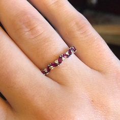 a woman's hand with a diamond ring on it