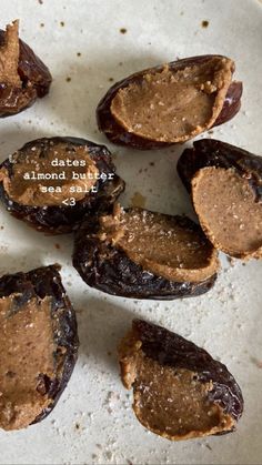 dates with almond butter are on a white plate