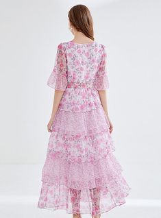 "Bathed in the soft blush of cherry blossoms, this enchanting tiered dress is a hymn to springtime romance. The delicate floral print weaves a narrative of blooming gardens and whispered tales of first love. Its graceful round neckline and sheer, breezy half-sleeves suggest an air of both demure charm and understated elegance. Cinched at the waist with an ornate rose buckle belt, the dress cascades down in ruffled layers, creating an ethereal sway with every step. This dress doesn't just capture Printing Skirt, Leaf Cake, Chiffon Floral Dress, Cake Skirt, Sleeveless Dresses Casual, Wildflower Meadow, Floral Chiffon Dress, Chiffon Floral, Lotus Leaf