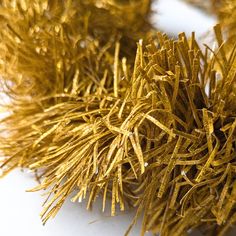 closeup of gold tinsel on white surface