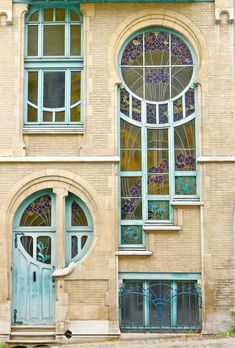 an old building with stained glass windows and arched doors