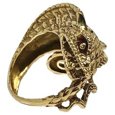 This authentic and menacing looking cobra ring is crafted in 18k yellow gold, and is replete over it's entire surface with total attention to detail, and is accented with black, white and cranberry color enamel. Measures 3/4 inches in width by a full 1 inch in length and rises 3/8 inches above the finger. Stamped inside the ring are 18k and a slightly obscured 750. The ring size is 5 1/2. Gross weight 9.75 grams. King Cobra Snake, K Ring, Serpent Snake, Cobra Snake, King Cobra, Snake Ring, 18k Yellow Gold Ring, Enamel Ring, Unique Gemstones