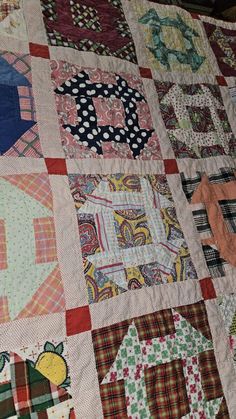 an old quilt is laying on top of a tablecloth that has been made into a house