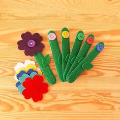 felt flowers and buttons laid out on a wooden surface