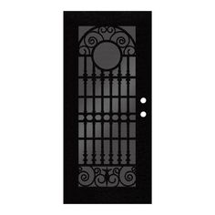 a black door with wrought iron designs on the side and two circles at the top