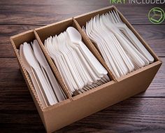 an open box filled with white plastic forks and spoons on top of a wooden table