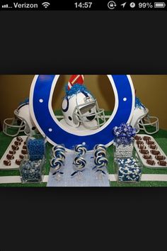 a football helmet on top of a table with candy in front of it and the number twenty