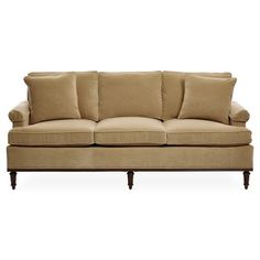 a tan couch with pillows on it