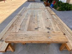 a wooden bench sitting on the side of a road