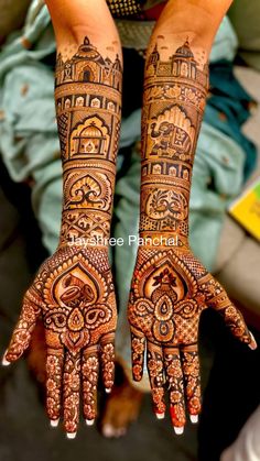 two hands with henna designs on them