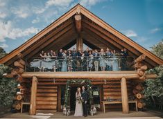 a group of people standing in front of a wooden building