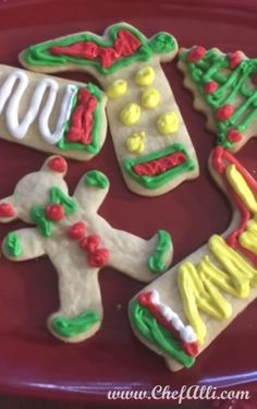 decorated cookies are arranged on a red plate