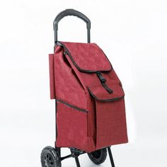 a red cart with wheels and a bag on it