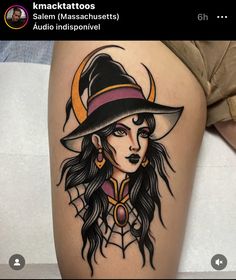 a woman with long hair wearing a witches hat and holding a moon tattoo on her thigh