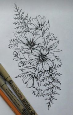 two pencils sitting next to each other on top of a sheet of paper with flowers drawn