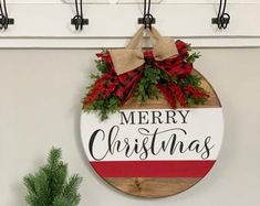 a merry christmas sign hanging on the wall