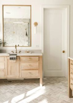 a bathroom with two sinks and a large mirror on the wall next to an open door