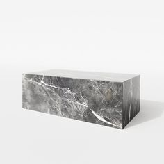 a marble block sitting on top of a white floor