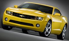 a yellow chevrolet camaro is shown in this image