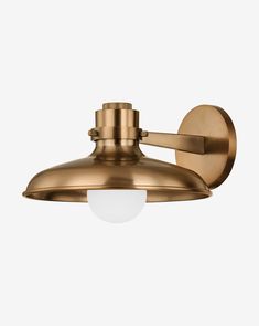 an antique brass wall light on a white background