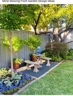 a small garden with blue and white vases on the table in front of it