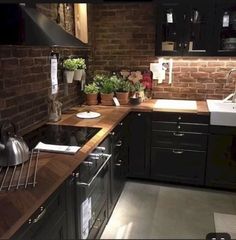 a kitchen with black cabinets and wooden counter tops