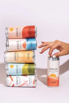 a hand reaching for a can of maker brand