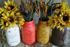 three painted mason jars with sunflowers in them