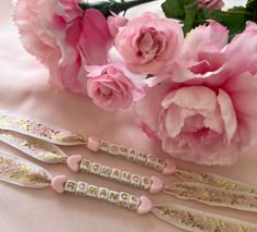 three pink flowers and some type of nameplates