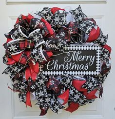 a black and red christmas wreath on a door