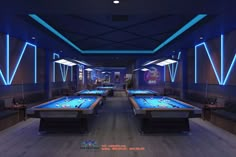 a room filled with pool tables covered in blue lights