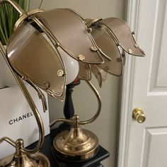 a pair of glasses sitting on top of a table next to a vase with flowers