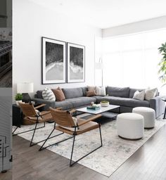 a living room filled with lots of furniture next to a large painting on the wall