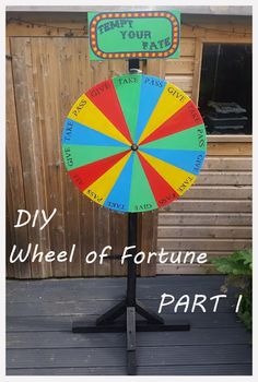 a colorful wheel of fortune sign sitting on top of a wooden table