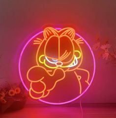 a neon sign with an image of garfield the cat on it's face and eyes