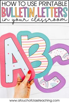 someone is holding up some paper letters with the words how to use printable bulletins in your classroom