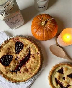 two pies and some candles on a table