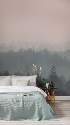 a bedroom with a bed, nightstand and wallpaper that has trees painted on it