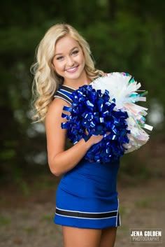 a cheerleader posing with her pom poms