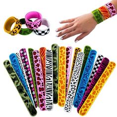 several bracelets with different designs on them and one being held by someone's hand