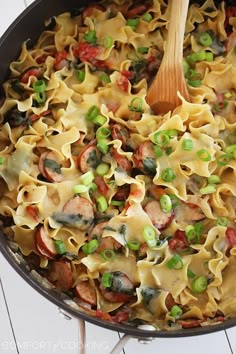 a skillet filled with pasta and peas