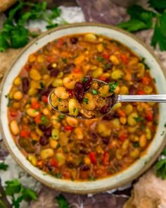 a spoon full of bean and vegetable soup