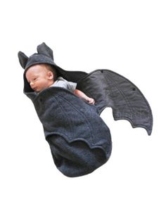 a baby in a bat costume flying through the air