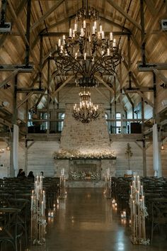 an indoor wedding venue with chandeliers and candles