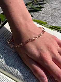 18-gauge 100% pure copper three piece dainty braided bangle bracelet.  Lightweight and comfortable design with delicate features. When exposed to the elements this metal shows colorful variations. Coppers thermal and electrical conductive qualities heighten your ability during spiritual practice of prayer and meditation. Due to this bracelet's delicate nature, be mindful not to bend. Bangle length is 9 inches. Comfortably fits up to 8 inch wrist Please keep in mind Copper naturally ages over time.  The patina of this piece will add to it's unique beauty! 🤎All of my jewelry is handmade and nonrefundable.  I encourage you to reach out with any questions if you are unsure about a piece! I am more than happy to answer and send additional pictures etc.  I cannot allow refunds due to a number o Adjustable Rose Gold Braided Bracelets, Bohemian Rose Gold Bangle Bracelets, Rose Gold Bohemian Bangle As Gift, Bohemian Rose Gold Bangle For Gift, Bohemian Rose Gold Bangle Gift, Adjustable Rose Gold Wire Wrapped Bracelets, Adjustable Rose Gold Braided Bracelet, Bohemian Rose Gold Wire Wrapped Bracelets, Rose Gold Bohemian Bracelets