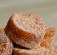 several sugared donuts stacked on top of each other