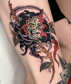 a woman's leg with a tattoo design on it