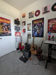 a room with guitars and posters on the wall